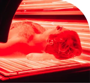 Close up of a man lying down in a full-body red light therapy bed Close up of a man lying down in a full-body red light therapy bed